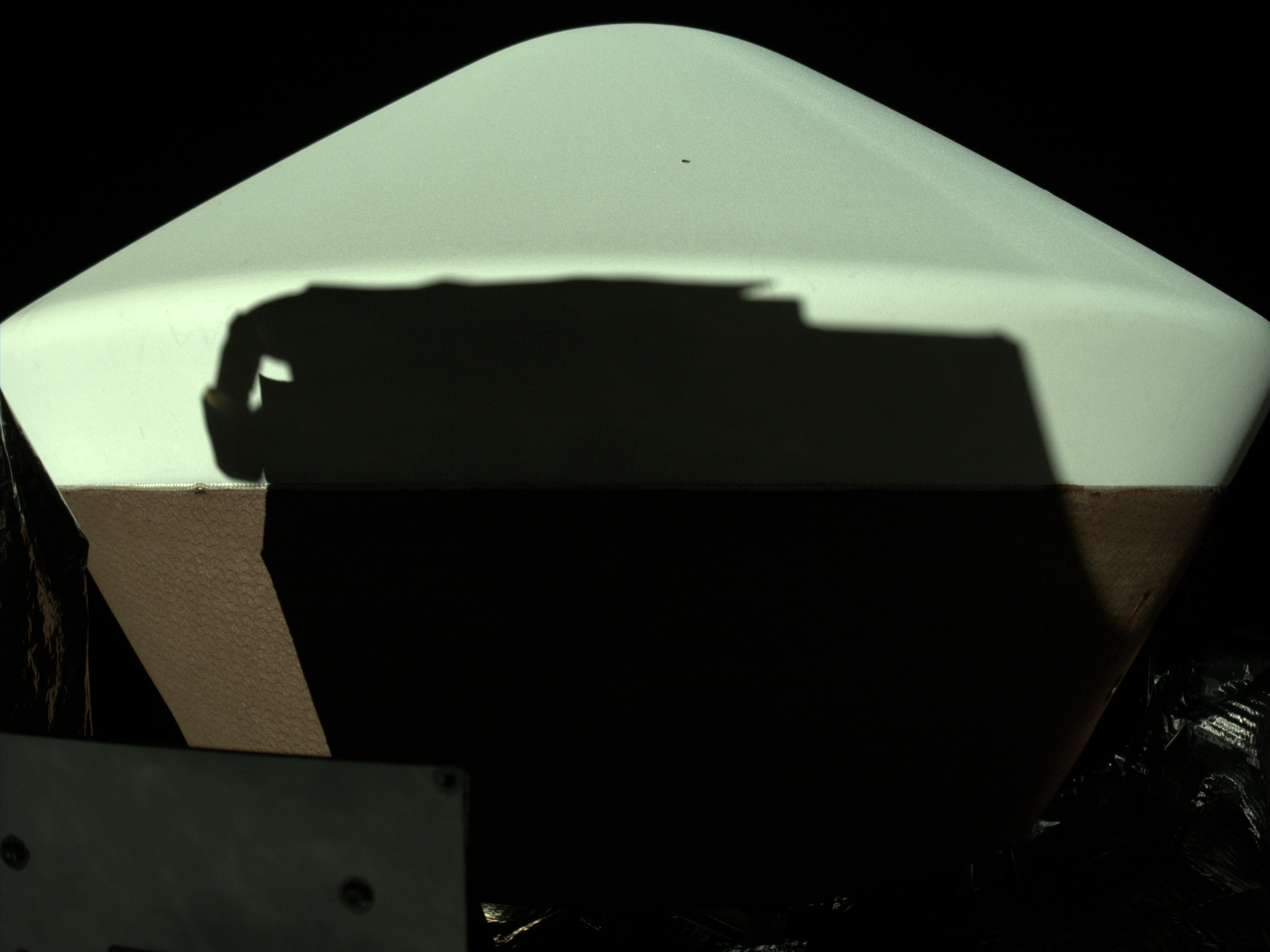 Shadow of REXIS instrument projected onto OSIRIS-REx Sample Return Capsule